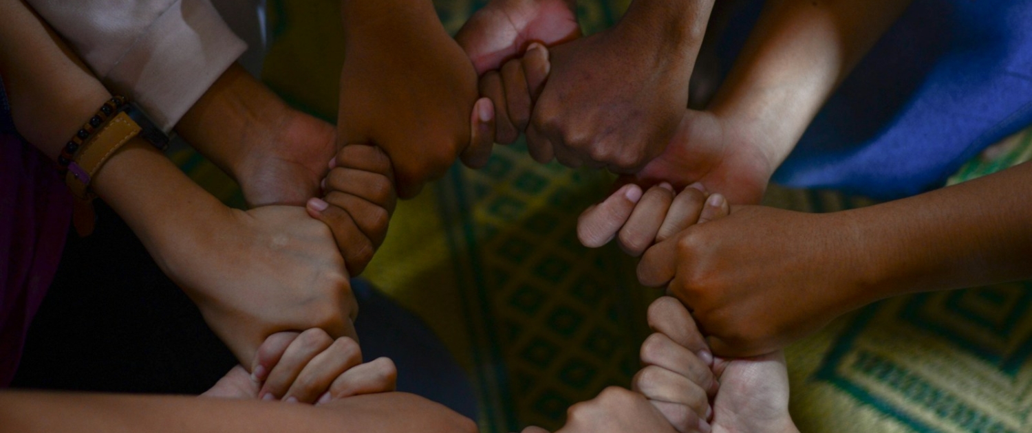 Photo by Wylly Suhendra man in white t-shirt holding babys hand